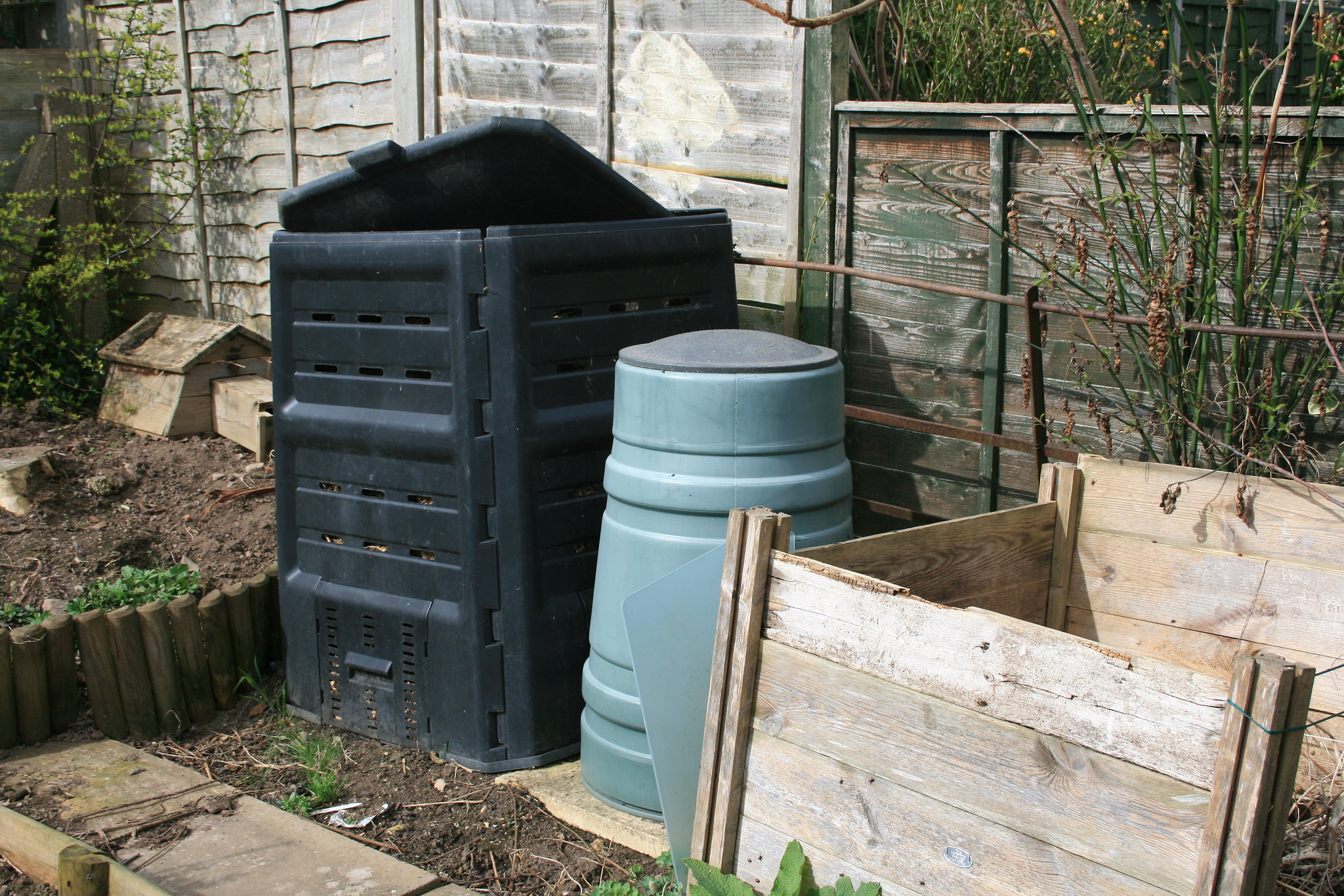 You can build a compost heap with wood, chicken wire, or purchase a plastic one online. 